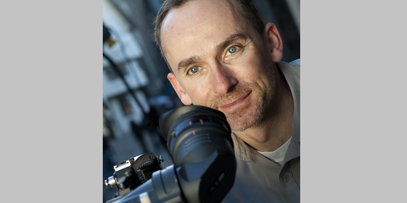 TV producer Julian Dismore close up holding video camera