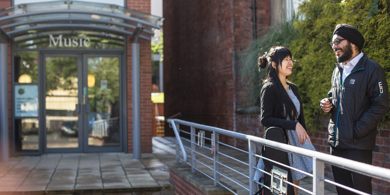 Two students outside of the School of Music entrance