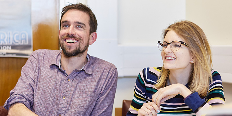 Two students laughing.