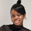 School of Music PhD student Michelle Ulor. Michelle stands against a white background and is looking at the camera and smiling.