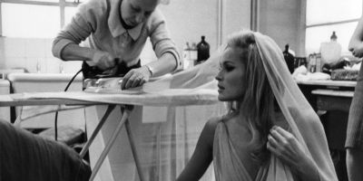 Wardrobe Mistress Jackie Cummins making sure that Ursula Andress is free of wrinkles for her starring role in She (1965)