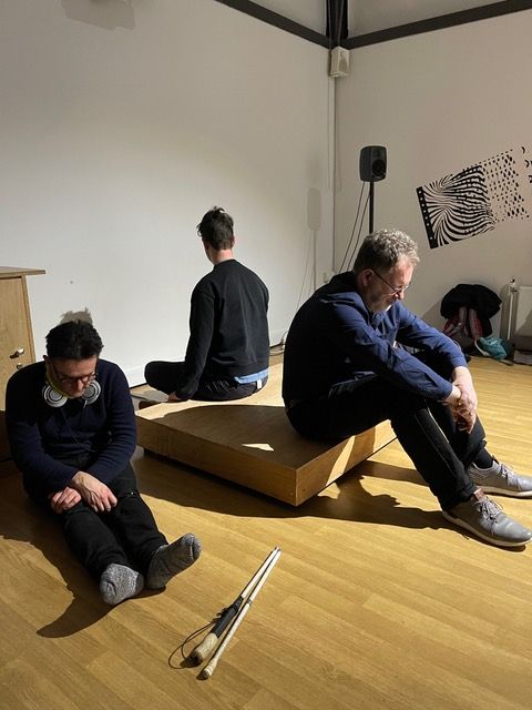 Three men sat down in a studio