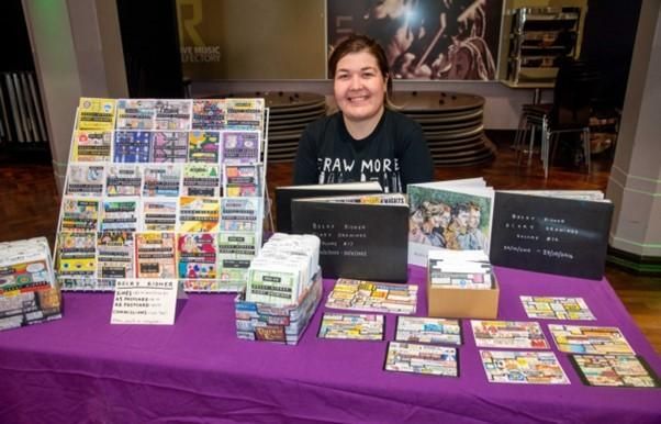 Zine expert Becky Kidner showcasing the zine on a table stand