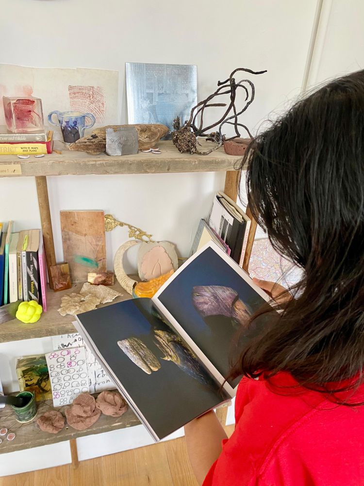 Person handling objects from archive on shelving made from reclaimed wood