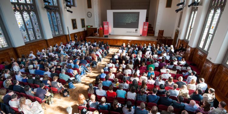 A room full of people listening to a lecture