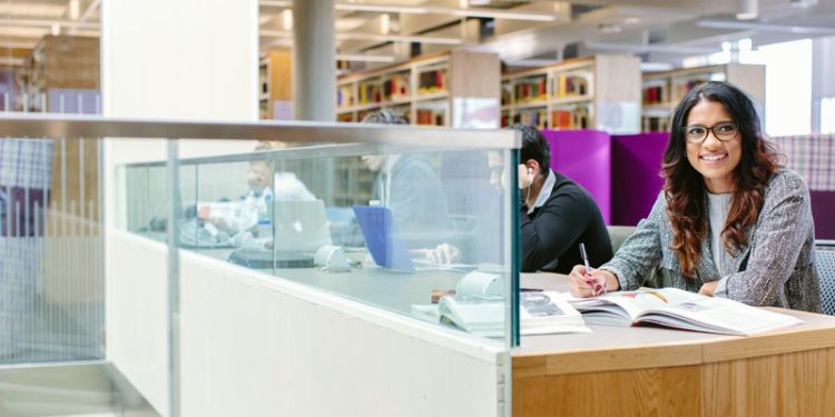 Student at a library desk.
