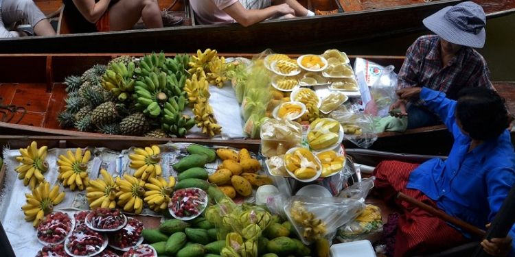 Thai vendors selling fruit and vegetables at a floating market