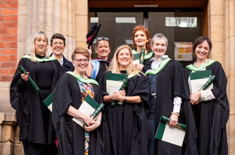 Group of university graduates outside the School of Fine Art, History of Art and Cultural Studies building in Leed