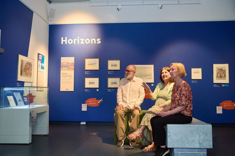 Visitors seated in a gallery space