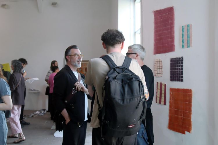 Visitors to an exhibition next to artist Hannah Sabapathy’s work