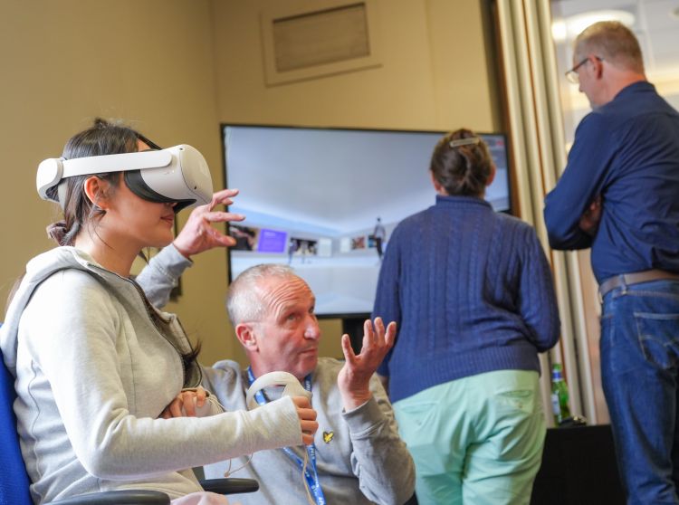 Attendees at the toolkit launch try VR headsets