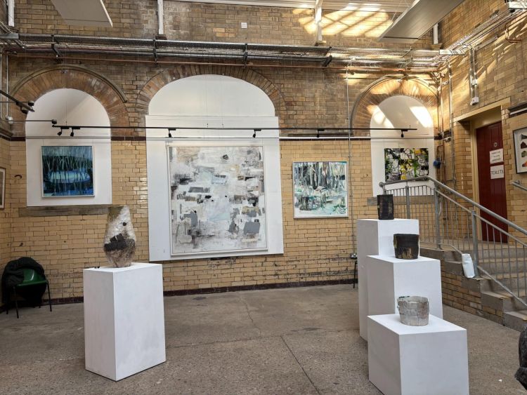 Exhibition in a gallery with a range of artworks