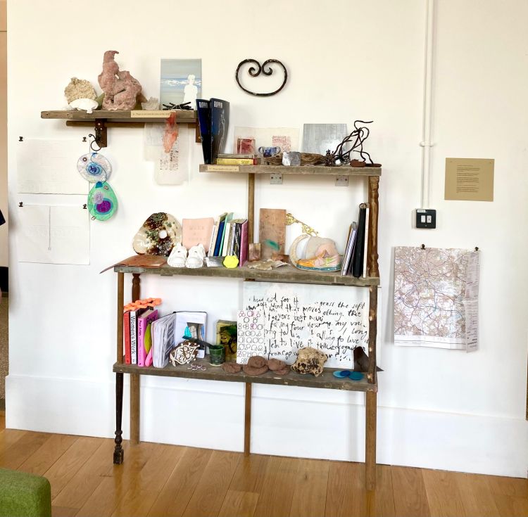 Archive of books and objects on shelving made from reclaimed wood