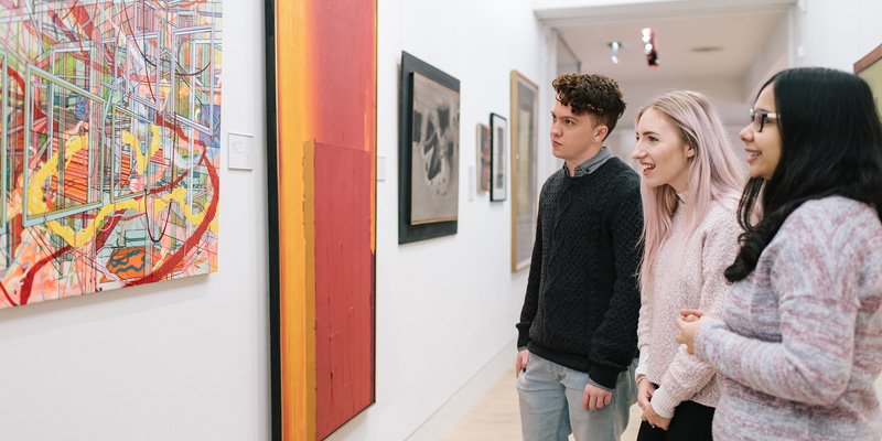 Students looking at artwork in a gallery