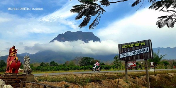 Cyclist in Thailand with mountains in the background