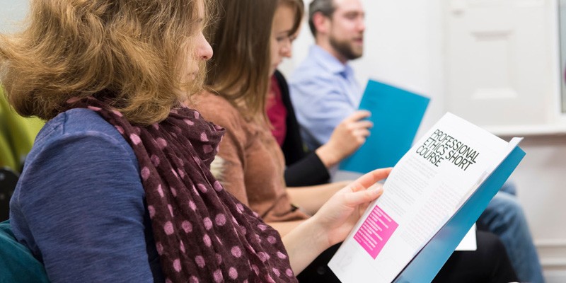 Students reading short course information