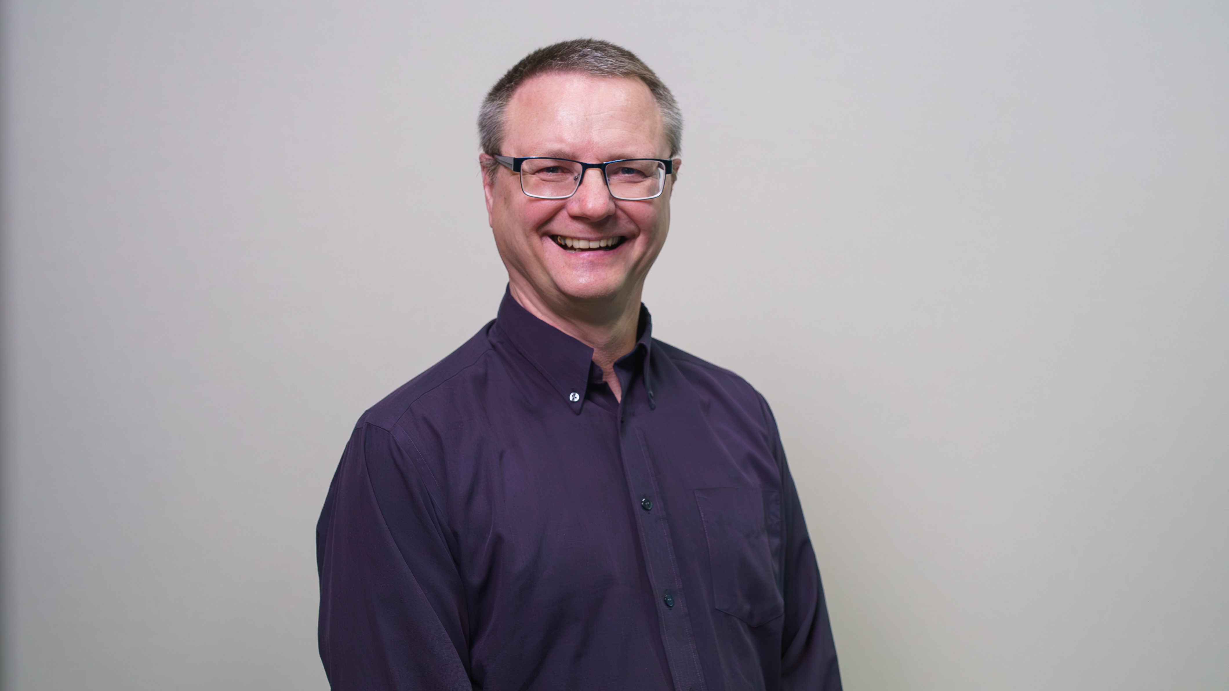 A man smiles at the camera