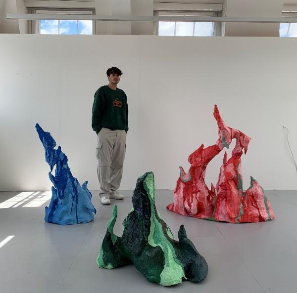 Artist Aasif Davidson with his sculptures at the University of Leeds BA Fine Art Degree Show.