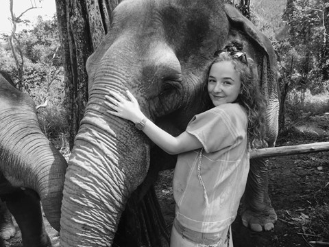 Student stood with an elephant in Thailand
