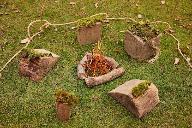 Sculptures made of natural materials such as wood placed on grass