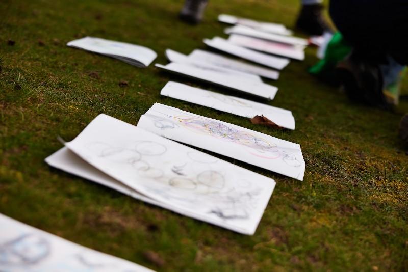 Line of drawings on paper placed on the ground