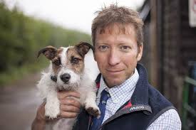 Little dog being held by the 'Yorkshire Vet'