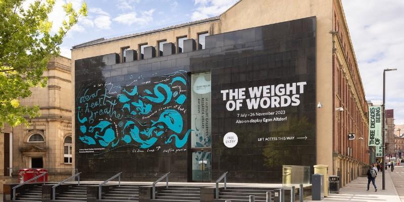 Photo of the outside of the Henry Moore Institute showing publicity for The Weight of Words exhibition