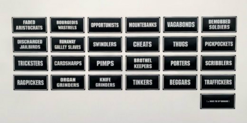 25 enamelled metal signs with black backgrounds and white writing.