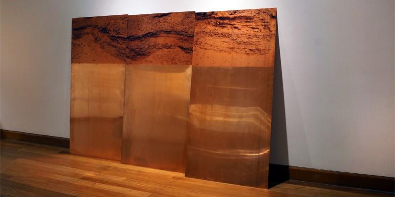 Installation by artist Fiorella Angelini made of copper plates with analogue photographs printed onto the substrate