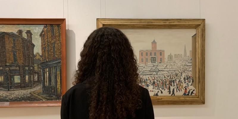 LS Lowry's painting Market Stalls on display in The Stanley & Audrey Burton Gallery