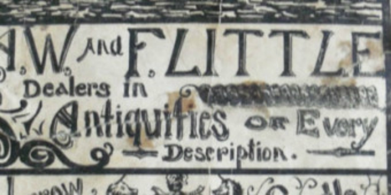 Black writing on old white paper. The words 'antiques' and 'dealers' can be made out.