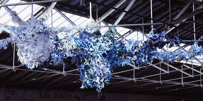 Art installation made of paper suspended from a ceiling, by artist Kelly Cumberland
