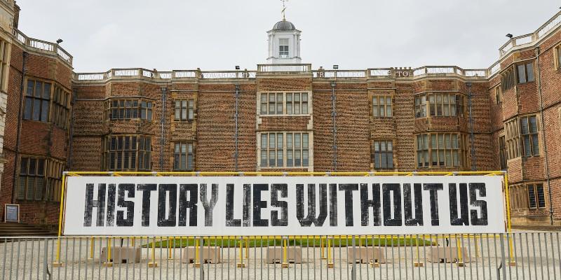 Temple Newsam House courtyard with art installation by People Powered Press in the foreground with the words history lies within us.