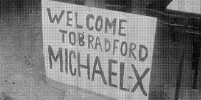 A black and white picture of a sign that reads &#039;Welcome to Bradford Michael X&#039; 
Picture via Who Needs A Heart, Black Audio Film Collective, 1991