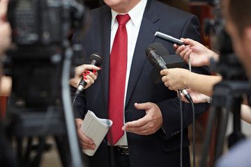 A politician being interviewed by journalists