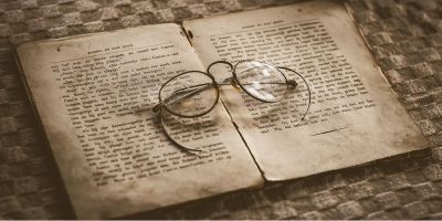 Antique spectacles resting on an old book