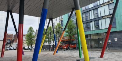 Image of public space courtyard with colourful poles