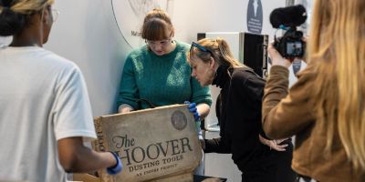 A group of people engaging with museum objects