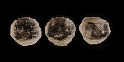 Three white bowls from an above view on a black background placed horizontally across the screen. The bowls contain black and white images developed on their surfaces depicting a range of scenes around Leeds