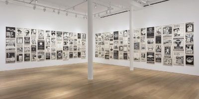 Photo of a gallery with work by Fernando Bryce titled The Decade Review.