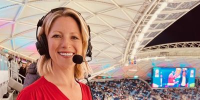 Jacqui Oatley, wearing a headset and looking at the camera