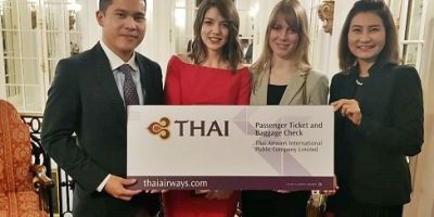 Lauren Avery receives her award, a return ticket to Thailand.