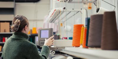 PACE Image - Shows Female technician using weaving/ knitting machine