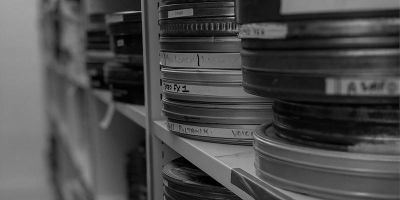 Image of film reels stacked high on shelves
