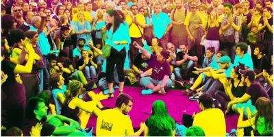 A poster with a photo of a group wearing vibrant multi-coloured clothes