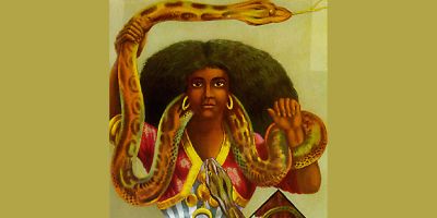 An interpretation of Mami Wata, with a red and yellow shawl, hoop earrings, holding a snake that curls round her neck and above her head.