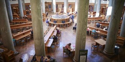 A photo of the Brotherton Library taken from the balcony, students can be seen studying at various desks.