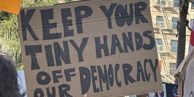 A photo of a cardboard placard held by a protestor at a demonstration