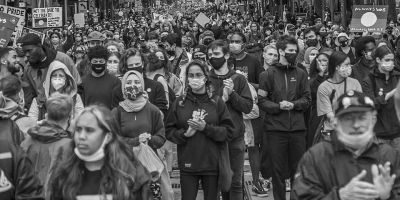 A black and white photo of a crowd facing the lens