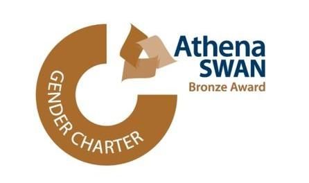 Bronze and blue logo, in blue font reads 'Athena Swan' to the top right. To the left is a bronze coloured circle that reads 'Gender charter'